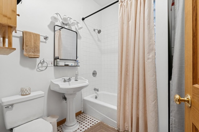 full bathroom featuring a sink, toilet, and shower / bath combination with curtain