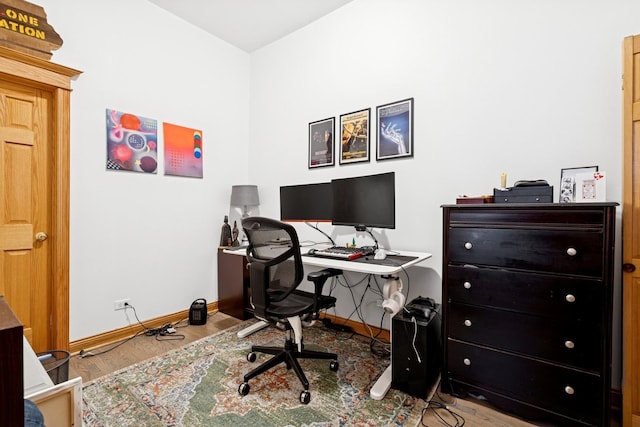 office space featuring baseboards and wood finished floors