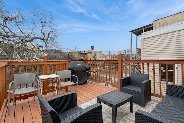 wooden terrace featuring a grill