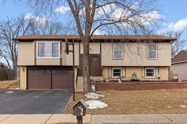 580 Whitehall Way, Bolingbrook, IL 60440 - split foyer home featuring aphalt driveway, brick siding, and an attached garage