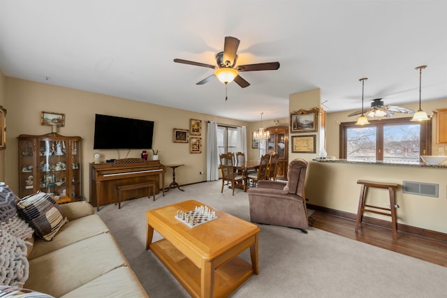 580 Whitehall Way, Bolingbrook, IL 60440 - living room featuring light carpet, ceiling fan with notable chandelier, baseboards, and visible vents
