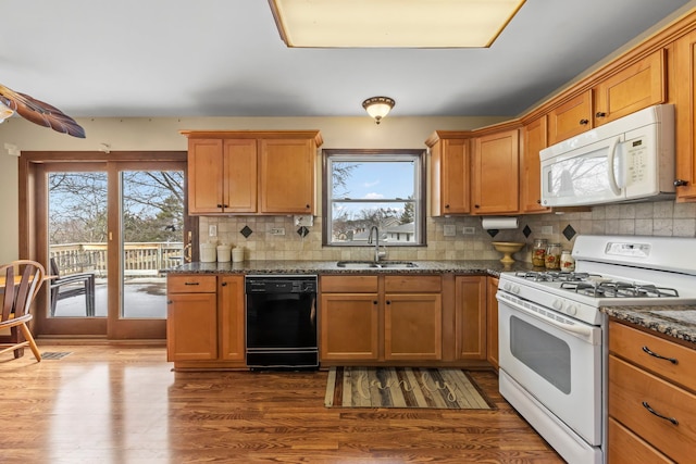 580 Whitehall Way, Bolingbrook, IL 60440 - kitchen featuring dark wood-style flooring, white appliances, dark stone counters, a sink, and backsplash