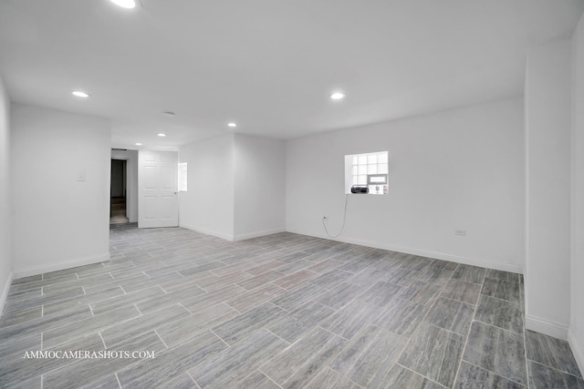 below grade area featuring recessed lighting, baseboards, and wood finish floors