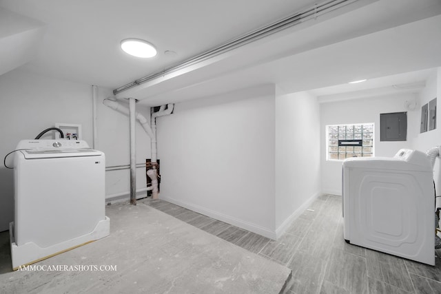 laundry area featuring electric panel, baseboards, independent washer and dryer, and laundry area