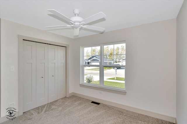 5656 Lantern Ln, Bourbonnais, IL 60914 - unfurnished bedroom with visible vents, baseboards, ceiling fan, a closet, and light colored carpet