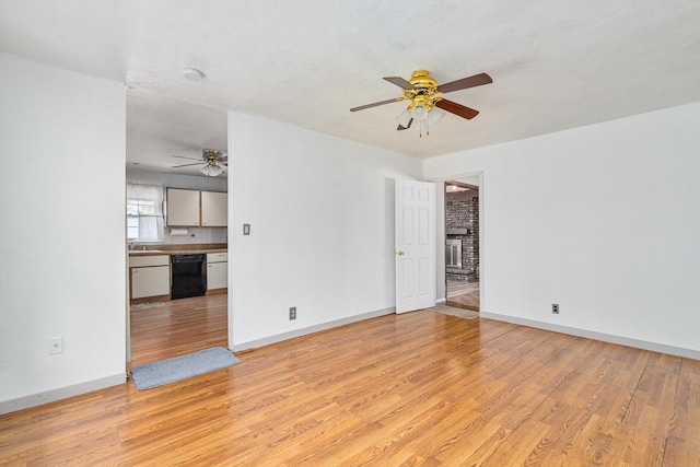 2201 W Acres Rd, Joliet, IL 60435 - spare room featuring ceiling fan, light wood-style flooring, baseboards, and a fireplace