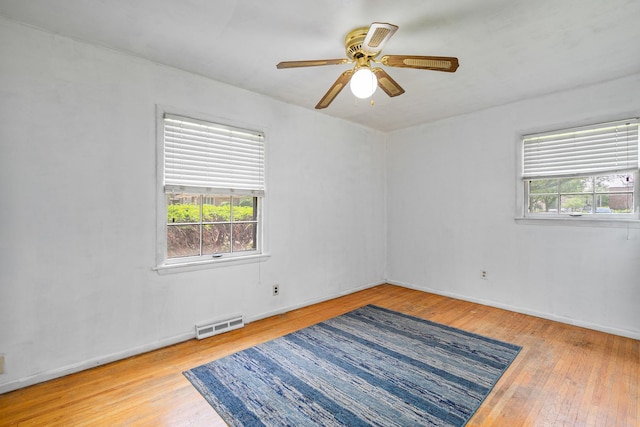2201 W Acres Rd, Joliet, IL 60435 - spare room featuring wood-type flooring, a ceiling fan, and baseboards