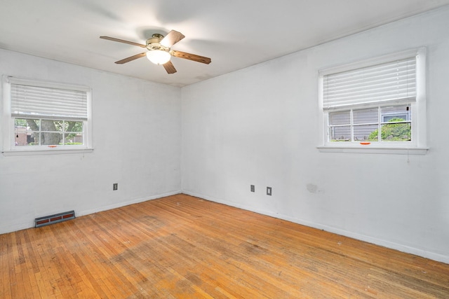 2201 W Acres Rd, Joliet, IL 60435 - unfurnished room featuring healthy amount of natural light, ceiling fan, hardwood / wood-style flooring, and baseboards