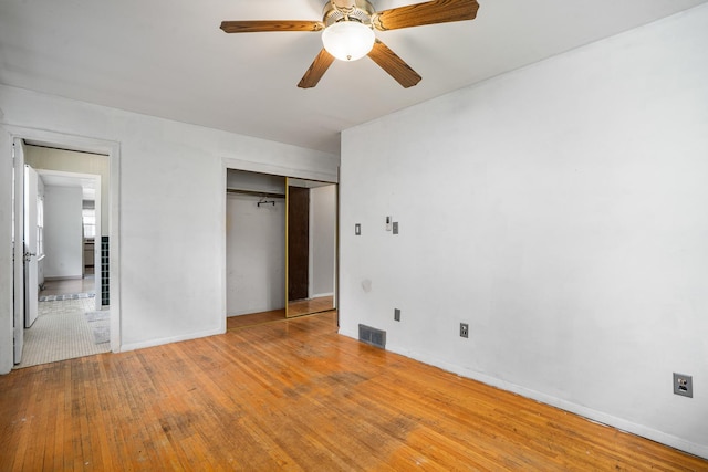 2201 W Acres Rd, Joliet, IL 60435 - unfurnished bedroom with hardwood / wood-style floors, a closet, baseboards, and a ceiling fan