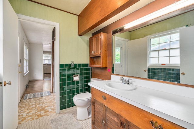 2201 W Acres Rd, Joliet, IL 60435 - bathroom with vanity, plenty of natural light, toilet, tile patterned flooring, and wainscoting