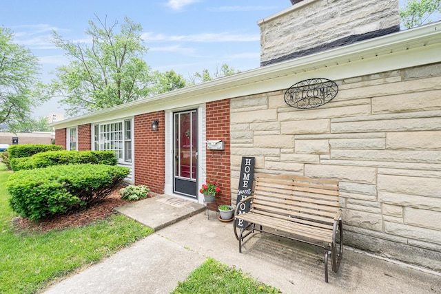 2201 W Acres Rd, Joliet, IL 60435 - doorway to property featuring stone siding, a chimney, and brick siding
