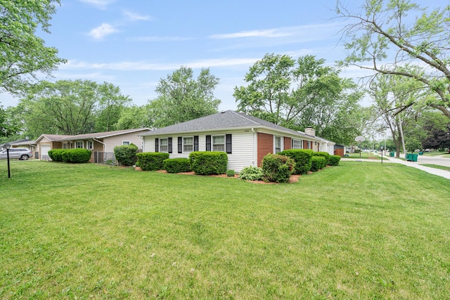2201 W Acres Rd, Joliet, IL 60435 - view of front facade featuring a front yard, an attached garage, brick siding, and a chimney