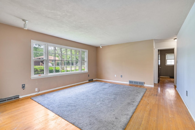 2201 W Acres Rd, Joliet, IL 60435 - spare room featuring baseboards and light wood-style floors