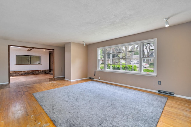 2201 W Acres Rd, Joliet, IL 60435 - empty room with baseboards, hardwood / wood-style flooring, and a textured ceiling