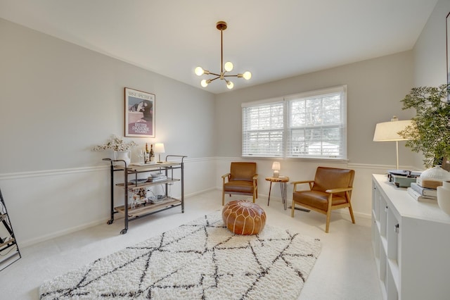 living area featuring carpet flooring and a chandelier