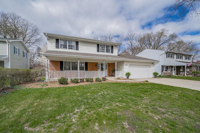 traditional home featuring concrete driveway, an attached garage, covered porch, brick siding, and a front yard