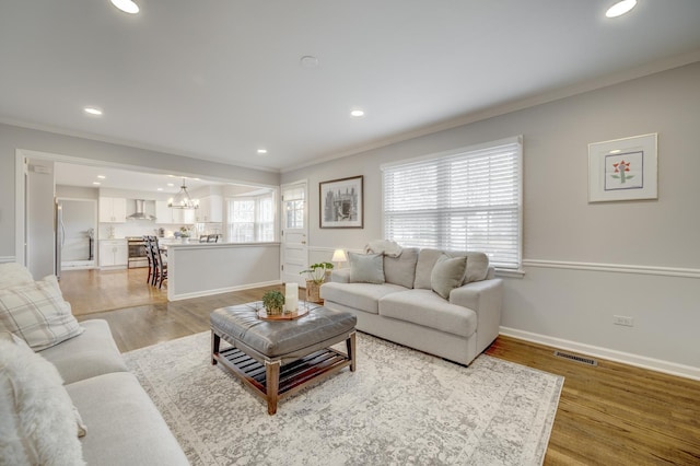 living room featuring crown molding and recessed lighting