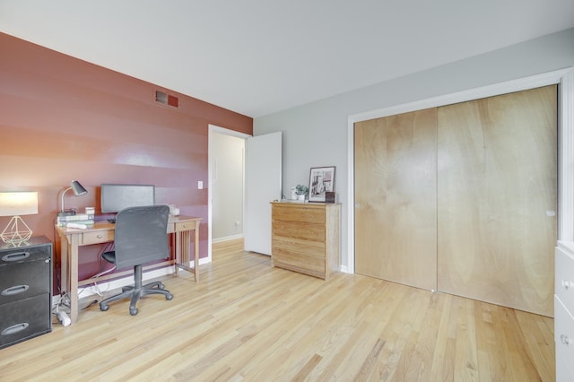 office space with wood finished floors and visible vents
