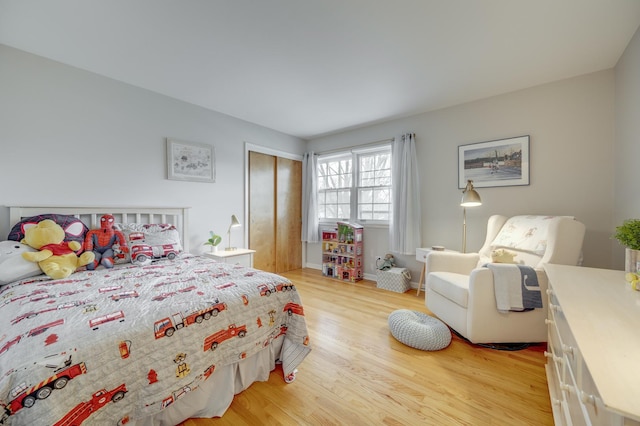 bedroom featuring a closet and light wood-type flooring