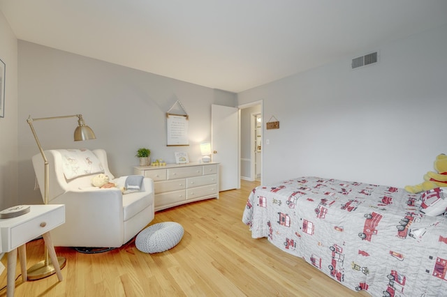 bedroom with visible vents and light wood finished floors