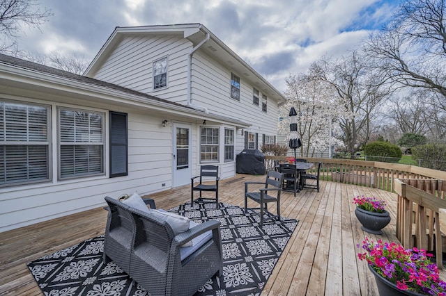 deck featuring grilling area and outdoor dining area
