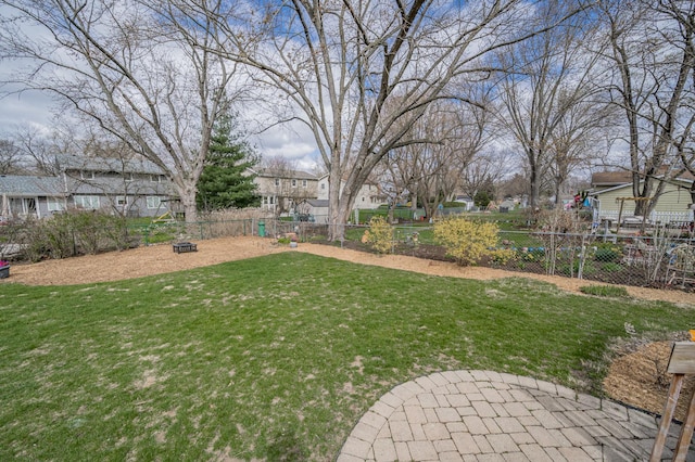 view of yard with a residential view, an outdoor fire pit, and fence