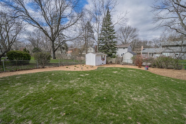 view of yard with an outbuilding, a shed, and a fenced backyard