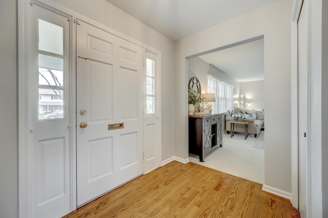 entrance foyer with light wood finished floors and baseboards