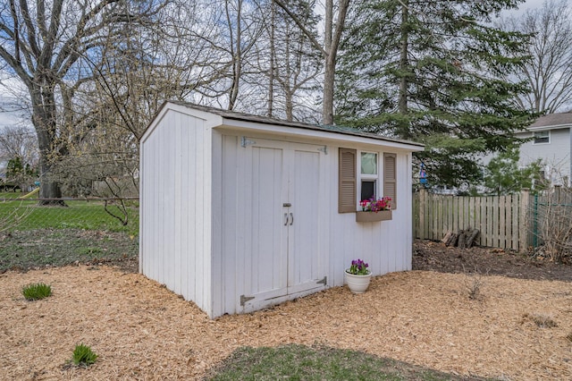 view of shed with fence
