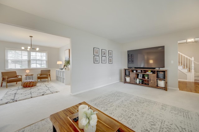 carpeted living room featuring stairway, baseboards, and a notable chandelier