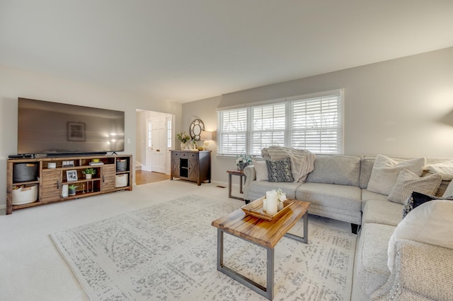 living room featuring carpet and baseboards