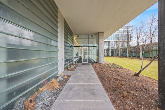 view of exterior entry featuring a yard