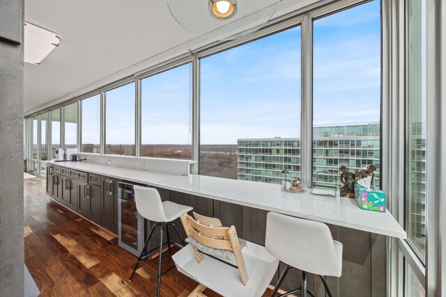office space featuring wine cooler and dark wood finished floors