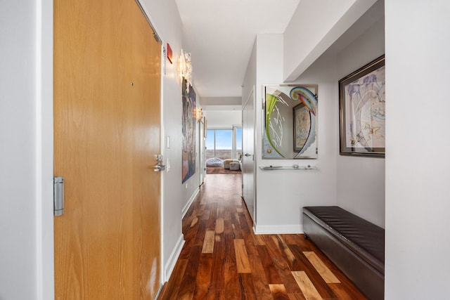 hall featuring baseboards and wood finished floors