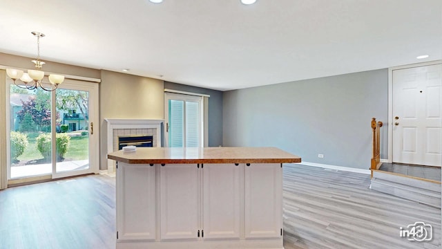 183 W Brandon Ct Unit C, Palatine, IL 60067 - kitchen featuring light wood finished floors, a chandelier, recessed lighting, baseboards, and white cabinetry
