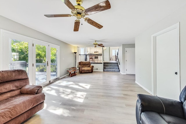868 Bonnie Brae Ln, Bolingbrook, IL 60440 - living room with a ceiling fan, baseboards, stairway, and light wood-type flooring