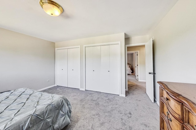 868 Bonnie Brae Ln, Bolingbrook, IL 60440 - unfurnished bedroom featuring baseboards, two closets, and carpet flooring