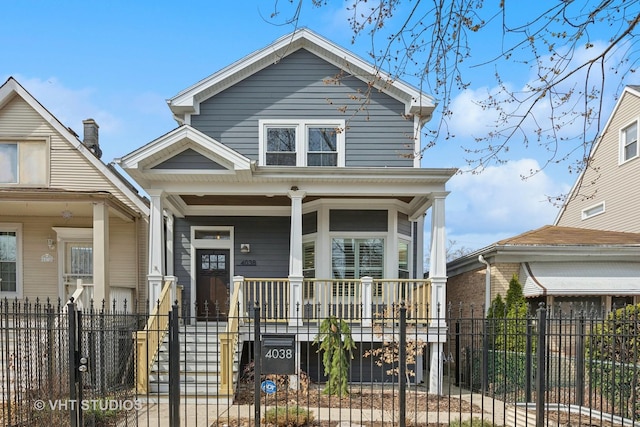 view of front facade with a porch, a gate, and a fenced front yard