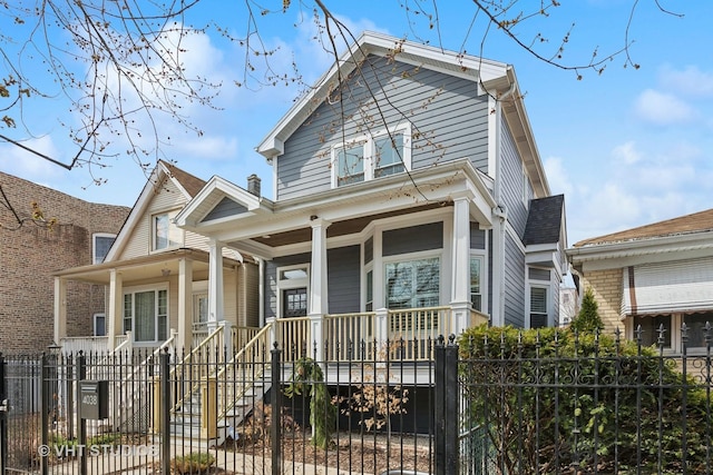 view of front facade featuring a porch and a fenced front yard
