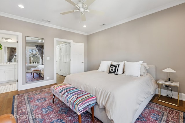 bedroom with ornamental molding, visible vents, recessed lighting, wood finished floors, and baseboards