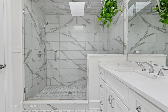 bathroom with a shower stall and vanity
