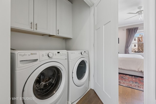 laundry area featuring washer and dryer, a ceiling fan, dark wood finished floors, crown molding, and cabinet space