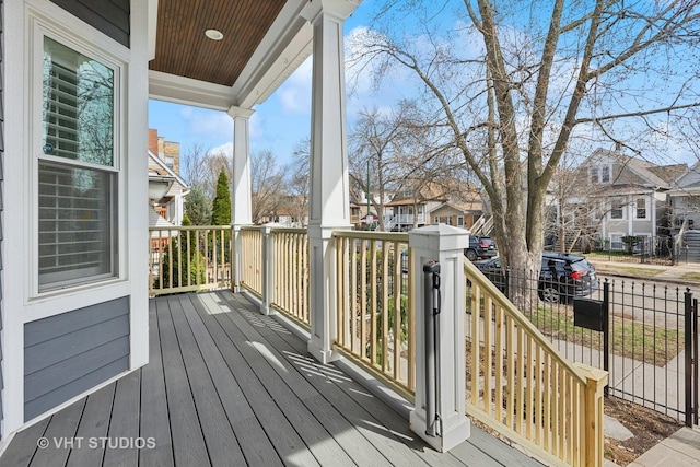 wooden terrace featuring a residential view