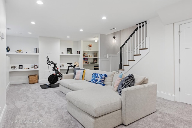 carpeted living room featuring baseboards, recessed lighting, stairs, visible vents, and built in shelves