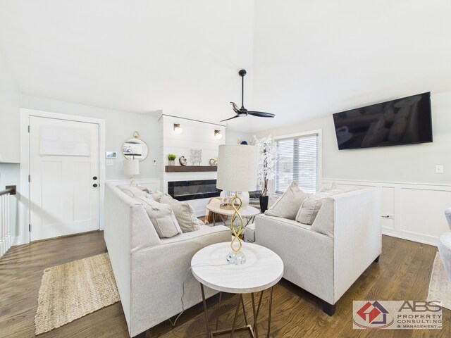439 Hoxie Ave, Calumet City, IL 60409 - living room with dark wood finished floors, a decorative wall, a ceiling fan, and a wainscoted wall