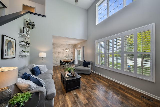 213 Dorset Ave, Oswego, IL 60543 - living area with a high ceiling, wood finished floors, and brick wall