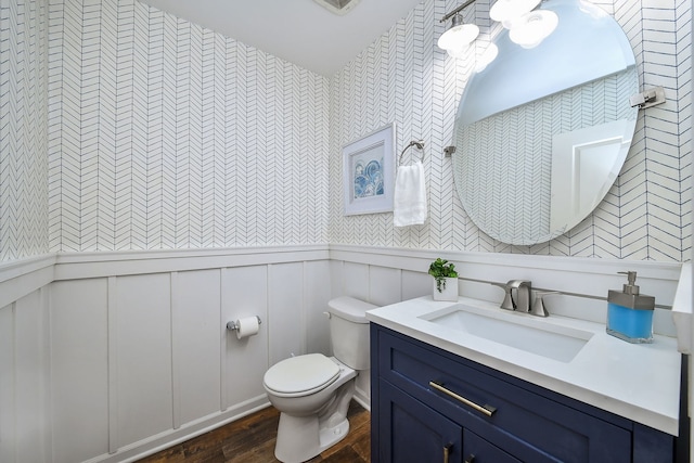 213 Dorset Ave, Oswego, IL 60543 - bathroom with vanity, wood finished floors, wallpapered walls, a wainscoted wall, and a decorative wall