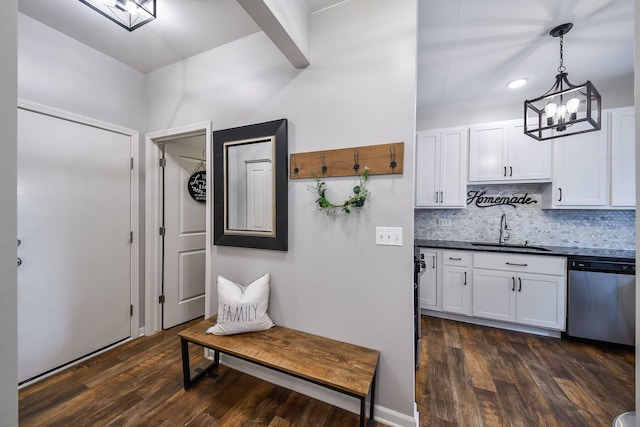213 Dorset Ave, Oswego, IL 60543 - kitchen featuring dishwasher, dark countertops, dark wood finished floors, backsplash, and a chandelier