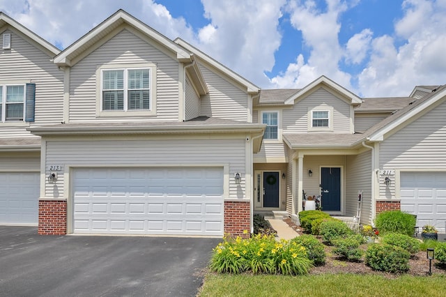 213 Dorset Ave, Oswego, IL 60543 - multi unit property featuring brick siding, asphalt driveway, and a garage
