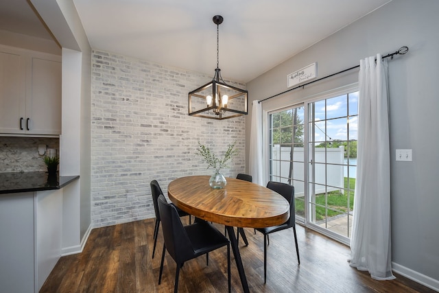 213 Dorset Ave, Oswego, IL 60543 - dining space featuring brick wall, a chandelier, dark wood-style floors, a water view, and an accent wall